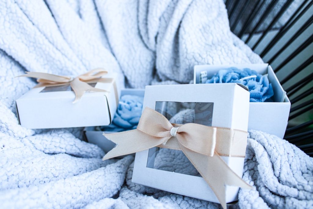 a white box with a bow on a blanket
